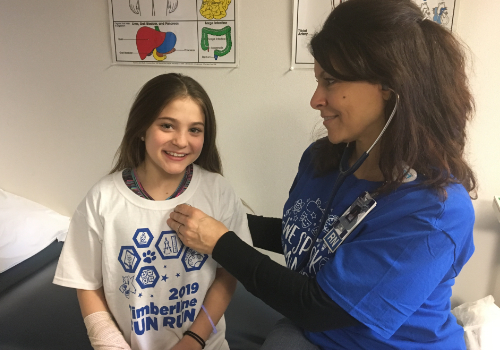 School nurse examines a student at Timberline Elementary School. School nurse examines a student at Timberline Elementary School.