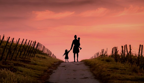 family walking into sunset family walking into sunset