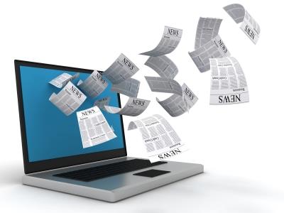 Computer with newspapers flying out 