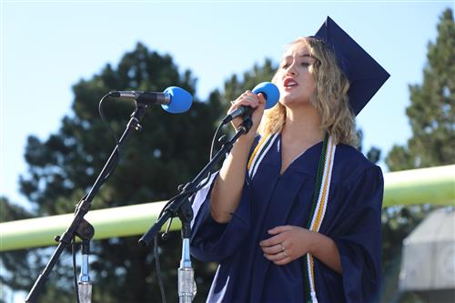 A student performs during the Overland High School graduation ceremony in July. 
