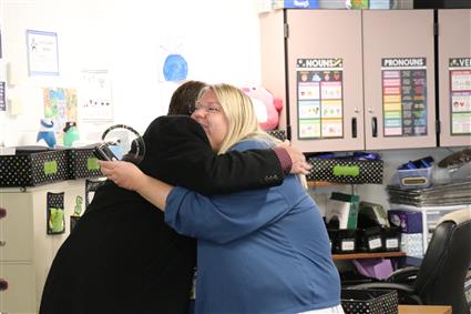 Superintendent Smith and honoree Arenello hugging after award presentation