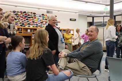 John sitting down talking to students