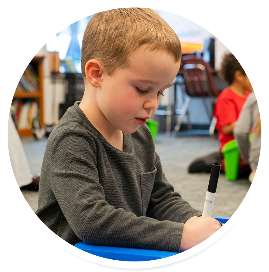 young student working with marker